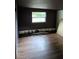 A room with damage to the bottom of the wall, and wood laminate flooring at 3614 E Grove St, Tampa, FL 33610