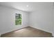Bright bedroom featuring wood-look flooring and a window at 3632 E Comanche Ave, Tampa, FL 33610