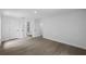 Bedroom displaying wood-look flooring, doors to bathroom at 3632 E Comanche Ave, Tampa, FL 33610
