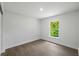 Cozy bedroom featuring wood-look flooring and a window with a view at 3632 E Comanche Ave, Tampa, FL 33610