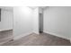 Bedroom with light-colored, wood-look flooring and blank walls, with a doorway to an adjacent room at 3632 E Comanche Ave, Tampa, FL 33610