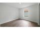 Cozy bedroom with clean white walls, modern flooring, and a window providing natural light at 3632 E Comanche Ave, Tampa, FL 33610