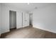 Bright bedroom with wood-look flooring, closet and a white door at 3632 E Comanche Ave, Tampa, FL 33610