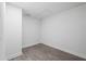 Bedroom with light-colored, wood-look flooring, blank walls, and a ceiling access panel at 3632 E Comanche Ave, Tampa, FL 33610