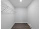 Walk in closet with wood-look flooring and wire shelving at 3632 E Comanche Ave, Tampa, FL 33610