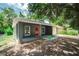 Charming single-story home with a covered front porch and a bright red front door at 3632 E Comanche Ave, Tampa, FL 33610