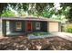 Inviting exterior with red door, complemented by a freshly poured concrete porch and driveway, plus a one-car garage at 3632 E Comanche Ave, Tampa, FL 33610