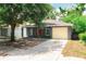 Charming home with a red front door, grey exterior, and a one-car garage with concrete driveway at 3632 E Comanche Ave, Tampa, FL 33610
