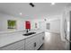 Updated kitchen with bright white countertops, modern black hardware, and stainless steel appliances at 3632 E Comanche Ave, Tampa, FL 33610