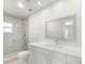 Bathroom features tiled shower, large mirror, and white vanity at 4016 Windtree Dr, Tampa, FL 33624