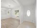 The entryway has hard wood floors and a view into a living space with large mirror and a window at 4016 Windtree Dr, Tampa, FL 33624