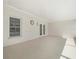Covered patio has neutral decor, window and french doors at 4016 Windtree Dr, Tampa, FL 33624