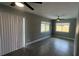 Open-concept living room featuring tile flooring, ceiling fan, and sliding glass doors to the backyard at 4374 32Nd N Ter, St Petersburg, FL 33713