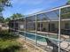 Relaxing screened-in pool area with outdoor seating, lush greenery, and sunny blue skies at 4374 32Nd N Ter, St Petersburg, FL 33713