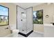 Bright bathroom featuring a frameless glass shower with black trim and modern fixtures at 4379 Porpoise Se Dr, St Petersburg, FL 33705