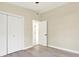 This bedroom features a ceiling fan, wood look floors, and a double door closet at 4379 Porpoise Se Dr, St Petersburg, FL 33705