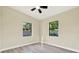 This bedroom has wood-look floors and two windows that provide lots of natural light at 4379 Porpoise Se Dr, St Petersburg, FL 33705