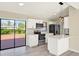 Well-lit kitchen with stainless steel appliances, backsplash, and slider door to the backyard deck at 4379 Porpoise Se Dr, St Petersburg, FL 33705