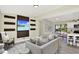 Open-concept living area with modern decor, gray sectional, and view of the kitchen at 4379 Porpoise Se Dr, St Petersburg, FL 33705