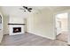 Cozy living room with stone fireplace, ceiling fan, and an open doorway to another room at 4379 Porpoise Se Dr, St Petersburg, FL 33705