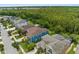 Aerial view of a home with a wooded backyard and a well-maintained neighborhood at 4383 Ortona Ln, Wesley Chapel, FL 33543