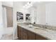 Bathroom featuring a granite countertop double vanity, modern fixtures, and a shower/tub combo at 4383 Ortona Ln, Wesley Chapel, FL 33543