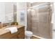 Bathroom featuring a shower, a granite countertop vanity, and modern fixtures at 4383 Ortona Ln, Wesley Chapel, FL 33543