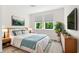 Inviting bedroom with a large window, stylish furniture, and a view of green landscape at 4383 Ortona Ln, Wesley Chapel, FL 33543