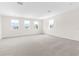 Bright bonus room with neutral carpet and multiple windows allowing for natural light at 4383 Ortona Ln, Wesley Chapel, FL 33543