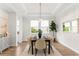 Formal dining room features a tray ceiling, a modern chandelier, and views to the exterior at 4383 Ortona Ln, Wesley Chapel, FL 33543