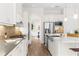 Modern kitchen features a large island, stainless steel appliances, and ample cabinet space for efficient cooking at 4383 Ortona Ln, Wesley Chapel, FL 33543