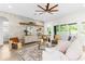 Comfortable living room with decorative brick wall, ceiling fan, and access to the outside patio at 4383 Ortona Ln, Wesley Chapel, FL 33543
