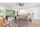 Spacious living room with an open layout flowing into the kitchen, creating a seamless and inviting living space at 4383 Ortona Ln, Wesley Chapel, FL 33543