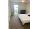 Bedroom with neutral walls, carpet, closet and balcony at 5155 9Th N Ave # 311, St Petersburg, FL 33710