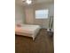 Carpeted bedroom featuring a ceiling fan, window, door, and mirrored shelf at 5155 9Th N Ave # 311, St Petersburg, FL 33710