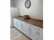 A hallway area features bright white cabinets and granite countertops with a view of a clock at 5155 9Th N Ave # 311, St Petersburg, FL 33710