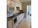 A kitchen with bright white cabinets, granite countertops, and stainless steel appliances at 5155 9Th N Ave # 311, St Petersburg, FL 33710