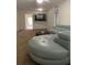A well-lit living room with an expansive sectional sofa and a view into the hallway at 5155 9Th N Ave # 311, St Petersburg, FL 33710