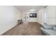 The living room features minimalist decor, with a mounted TV and a glimpse into the kitchen at 5155 9Th N Ave # 311, St Petersburg, FL 33710