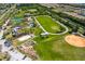The aerial photo shows a community park with a track, tennis courts, athletic fields, and community garden at 540 Firefly Ln, Apollo Beach, FL 33572
