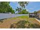 Spacious backyard with lush green grass, a privacy fence, and a screened-in lanai at 540 Firefly Ln, Apollo Beach, FL 33572