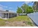 Expansive backyard boasts a screened-in porch and ample space for outdoor activities at 540 Firefly Ln, Apollo Beach, FL 33572