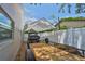 Wide backyard featuring a parking area, a trailer and a white privacy fence at 540 Firefly Ln, Apollo Beach, FL 33572