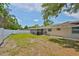 Lush backyard featuring a screen lanai, well-maintained lawn, and privacy fence at 540 Firefly Ln, Apollo Beach, FL 33572