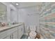 Bathroom with double vanity, granite countertop, toilet, and a shower curtain at 540 Firefly Ln, Apollo Beach, FL 33572