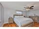 Bedroom with wooden floors, wood furniture, and a ceiling fan with lights at 540 Firefly Ln, Apollo Beach, FL 33572