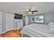 Bedroom with wood floors, a dresser, and a mirror, plus a doorway to the bathroom at 540 Firefly Ln, Apollo Beach, FL 33572