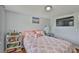 Bedroom featuring light gray walls, a window with blinds, and a decorative bedspread at 540 Firefly Ln, Apollo Beach, FL 33572