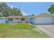 Inviting single-Gathering home features a two-car garage and an eye-catching blue front door at 540 Firefly Ln, Apollo Beach, FL 33572