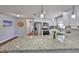 Kitchen with a speckled stone countertop island, stainless steel appliances, and hardwood floors at 540 Firefly Ln, Apollo Beach, FL 33572